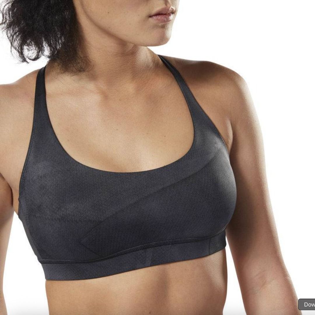 Reebok Grey Sports Bra (Category: Activewear) located in Mandaluyong City. Submitted by alyscloset_ (Listing ID 1428439163, Image 2). Description: Reebok sports bra features a racerback design and a supportive fit. It is a dark grey color. The bra has a textured pattern on the fabric. The bra has a comfortable underbust band..