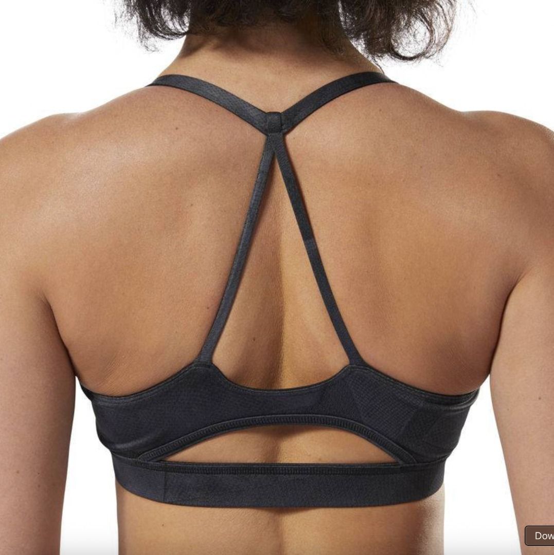 Reebok Grey Sports Bra (Category: Activewear) located in Mandaluyong City. Submitted by alyscloset_ (Listing ID 1428439163, Image 3). Description: Reebok sports bra features a racerback design and a supportive fit. It is a dark grey color. The bra has a textured pattern on the fabric. The bra has a comfortable underbust band..