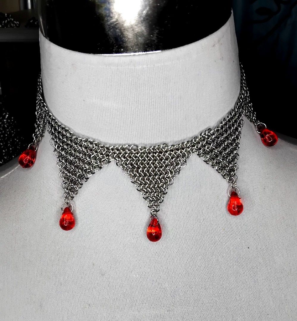 Silver Chainmail Choker Necklace with Red Beads (Category: Necklaces) located in Baguio. Submitted by depressed_pastelhead (Listing ID 1428602585, Image 2). Description: Elegant silver chainmail choker necklace featuring a unique design. The necklace has a series of triangular drops, each adorned with a vibrant red bead. The chainmail is intricately woven, creating a delicate yet eye-catching piece. Perfect for adding a touch of sophistication to