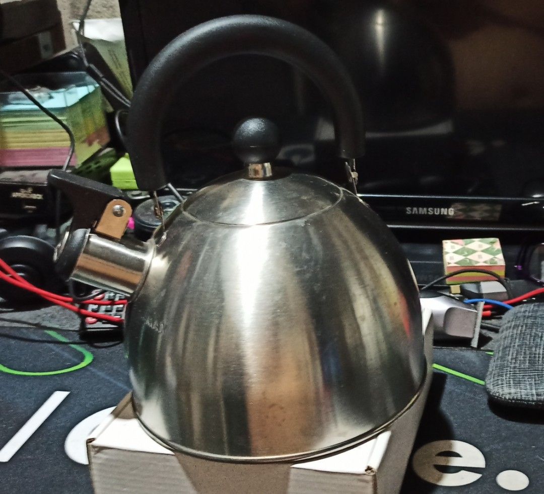 Stainless Steel Kettle (Category: Kettles & Airpots) located in Makati City. Submitted by jerrymontano (Listing ID 1428449019, Image 1). Description: Stainless steel kettle features a black handle and a whistle. The kettle is a good size for making tea or coffee. It is a practical and stylish addition to any kitchen..