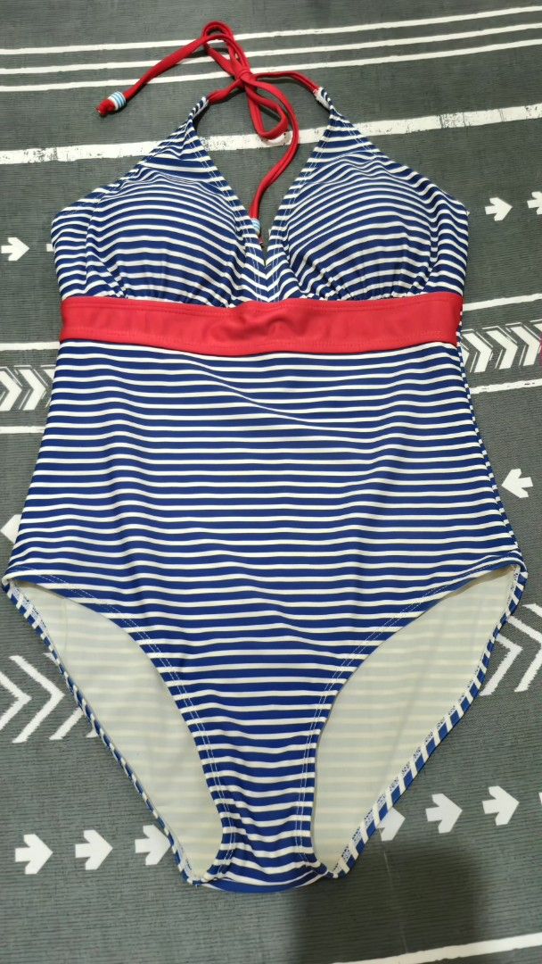 Swimsuit for women (Category: Bikinis & Swimsuits) located in Paranaque City. Submitted by nieshaprelovedshop (Listing ID 1428595816, Image 1). Description: Swimsuit features a blue and white striped pattern with a red accent. It has a halter neck design and a one-piece style. It is a stylish choice for the beach or pool..
