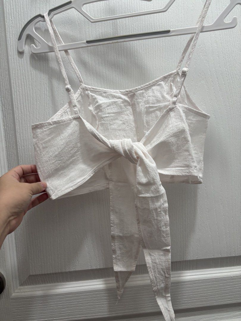 Tie back crop top - white (Category: Sleeveless) located in Makati City. Submitted by declutterwithmeeeee (Listing ID 1428597388, Image 2). Description: long straps at the hem that can be tied into a beautiful ribbon bow in the back. Summer | beach wear | casual wear.
