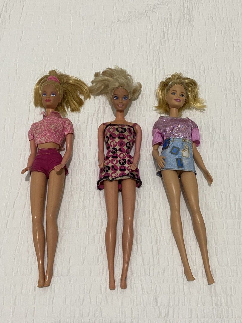 Vintage Barbie Dolls bundle (Category: Kids Toys) located in Balanga. Submitted by vintagefanatics (Listing ID 1428465572, Image 2). Description: Three vintage Barbie dolls with blonde hair. One doll is wearing a pink patterned top and shorts. Another doll is wearing a pink and black patterned dress. The third doll is wearing a pink sequined top and a denim skirt. .
