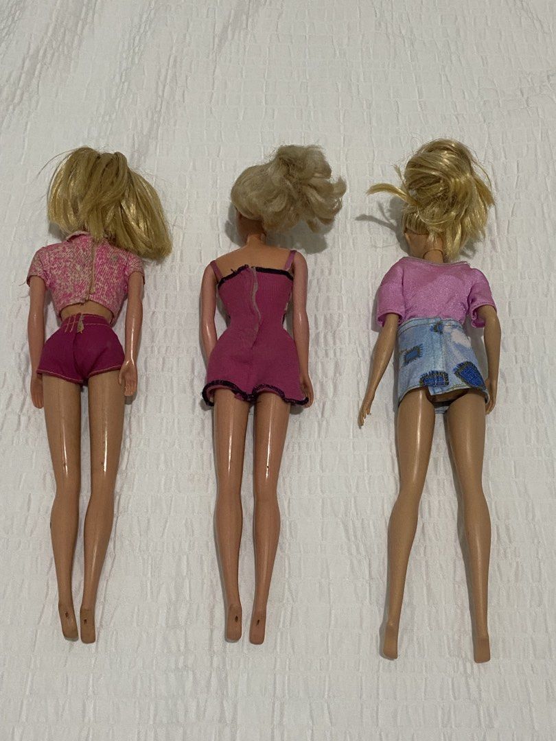 Vintage Barbie Dolls bundle (Category: Kids Toys) located in Balanga. Submitted by vintagefanatics (Listing ID 1428465572, Image 3). Description: Three vintage Barbie dolls with blonde hair. One doll is wearing a pink patterned top and shorts. Another doll is wearing a pink and black patterned dress. The third doll is wearing a pink sequined top and a denim skirt. .