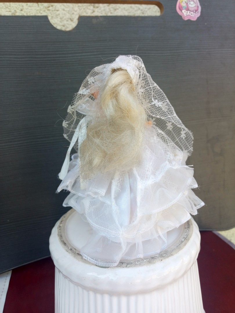 Vintage Bride Barbie Doll cake display (Category: Figurines & Statues) located in Marikina City. Submitted by norman213 (Listing ID 1428438406, Image 3). Description: Vintage Barbie doll is dressed as a bride. She is wearing a white wedding dress with a veil. The doll is standing on a white base. The doll has blonde hair and blue eyes..