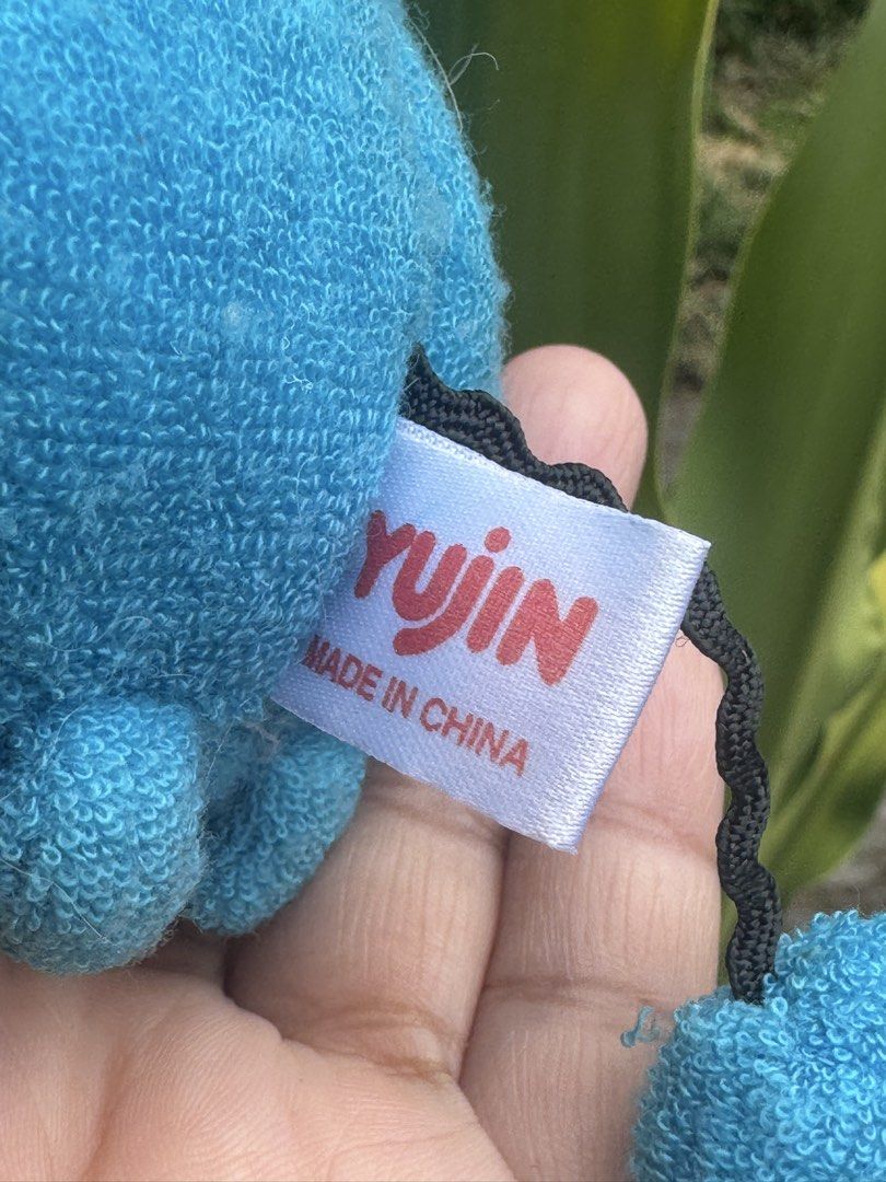 Yujin Pokemon Marill Plush Toy (Category: Plushies & Soft Toys) located in Antipolo. Submitted by bhabiegraciefashionlab (Listing ID 1428491006, Image 3). Description: Adorable Marill plush toy from Yujin. Features a blue body with red ears and a white belly. Includes a black string and a tag that reads "Made in China". The tag also indicates Nintendo Creatures, Game Freak, Tokyo, Shop Pro, and Jaikaku. A cute addition to any Pokemon collection!.