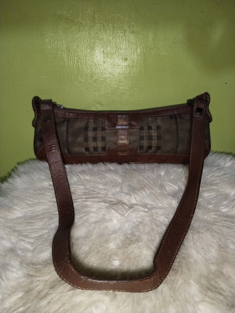 Burberry Shoulder Bag (Category: Luxury Bags & Wallets) located in Bacolod City. Submitted by maejuntado33 (Listing ID 1428712911, Image 1). Description: Authentic Burberry shoulder bag. Features a classic check pattern with brown leather trim and strap. The bag has a zipper closure and a small interior pocket. Made in Italy..
