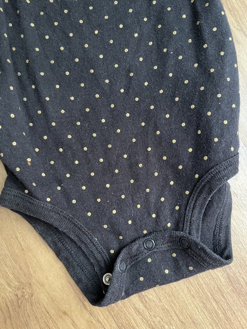 Carter's 18M Black Polka Dot Onesie (Category: Babies & Kids Fashion) located in Manila. Submitted by gtwins (Listing ID 1428670128, Image 2). Description: Carter's onesie is designed for babies aged 18 months. It features a black base with gold polka dots and long sleeves. The onesie has snap closures at the bottom for easy diaper changes. Made in Cambodia..