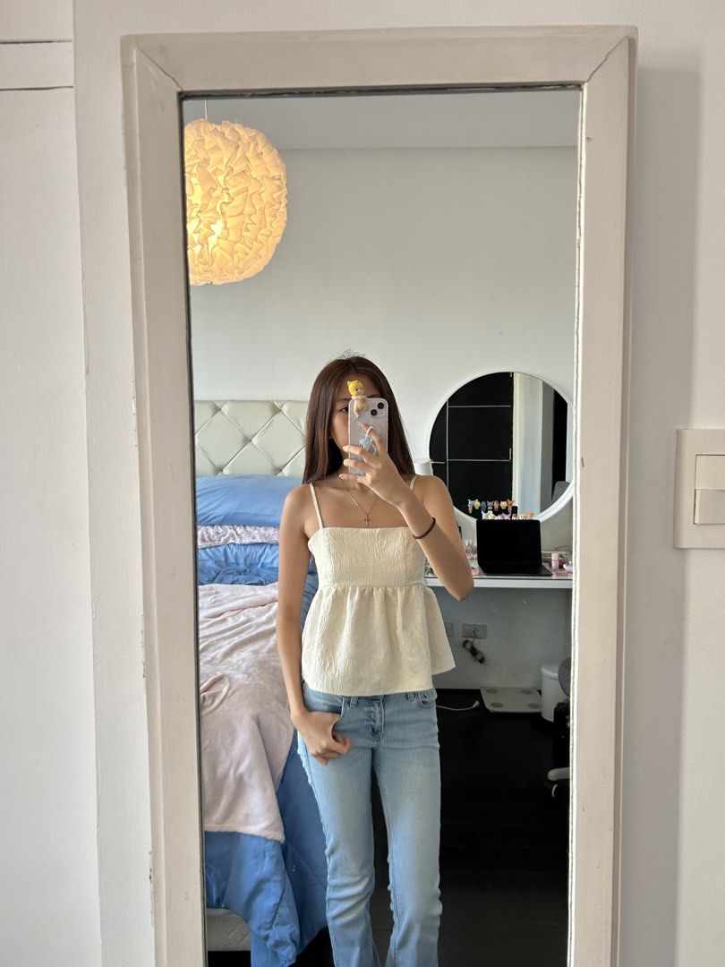 Cream-colored Cami Top (Category: Sleeveless) located in Manila. Submitted by rayennss (Listing ID 1428694518, Image 2). Description: Cream-colored cami top features a square neckline and adjustable straps. It has a textured fabric and a peplum-style hem. The top is suitable for casual wear and can be paired with jeans or skirts. It is a versatile piece for your wardrobe..