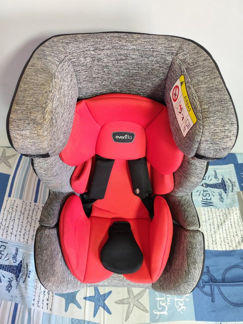 Evenflo Car Seat (Category: Car Seats) located in Bacoor. Submitted by acm.cm (Listing ID 1428745643, Image 2). Description: Evenflo car seat features a red and gray design. It has a headrest and adjustable straps for safety. The seat is designed for different weight groups, as indicated on the labels. It includes an airbag warning and instructions for proper installation..