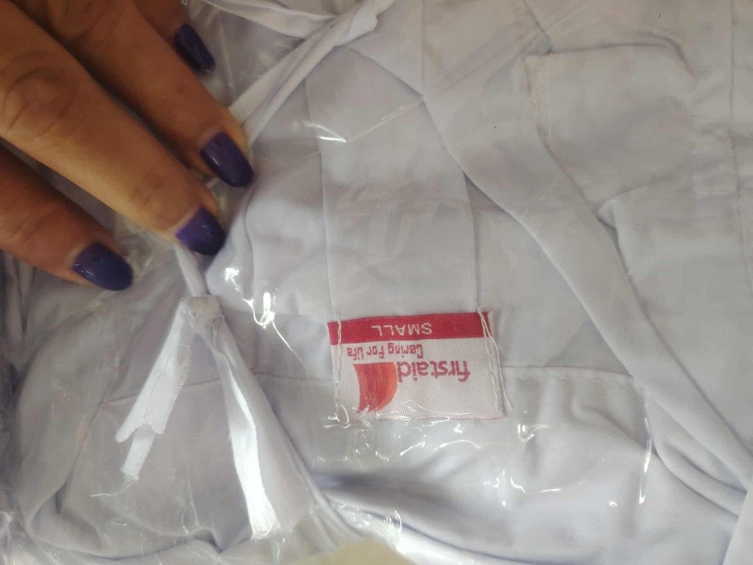 Firstaid Lab Coat - X-Small and Small (Category: Other Assistive Aids) located in Manila. Submitted by marino06 (Listing ID 1428702124, Image 3). Description: White lab coats from Firstaid. Available in X-Small and Small sizes. Each coat is individually packaged in plastic. The coats have a red label with the Firstaid logo and the words "Caring for Life"..