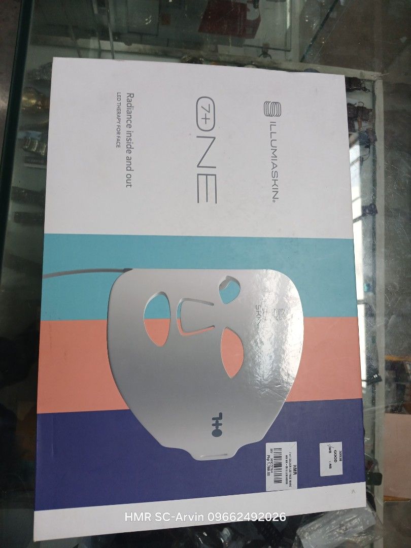 IllumiaSkin 7+ ONE LED Therapy Face Mask (Category: Face Care) located in Manila. Submitted by sc_arvin (Listing ID 1428637297, Image 1). Description: IllumiaSkin 7+ ONE LED therapy face mask. The box shows the mask with a colorful design. It is designed for radiance inside and out. The mask has a face-shaped design with openings for the eyes, nose, and mouth. The box also has the HMR SC - Arvin 09662492026 contact information..