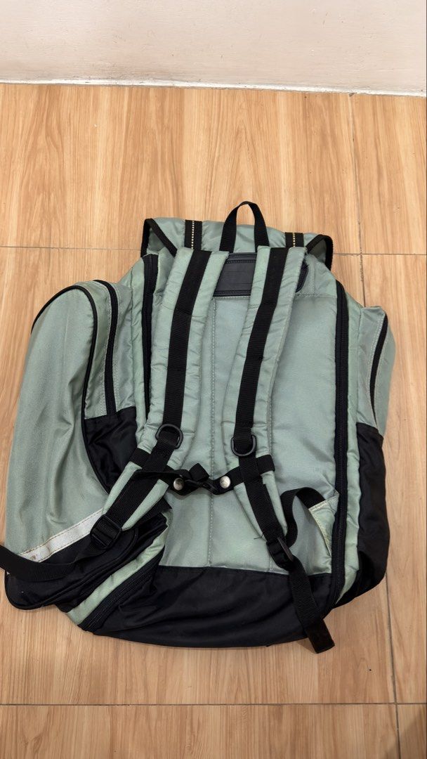 Kangol Backpack (Category: Backpacks) located in Alfonso. Submitted by jbcamet (Listing ID 1428717565, Image 3). Description: Kangol backpack features a light green and black color scheme. It has multiple compartments, including side pockets and a front pocket. The backpack has adjustable straps and a top handle. The main compartment has a drawstring closure. The Kangol logo is visible on the front..