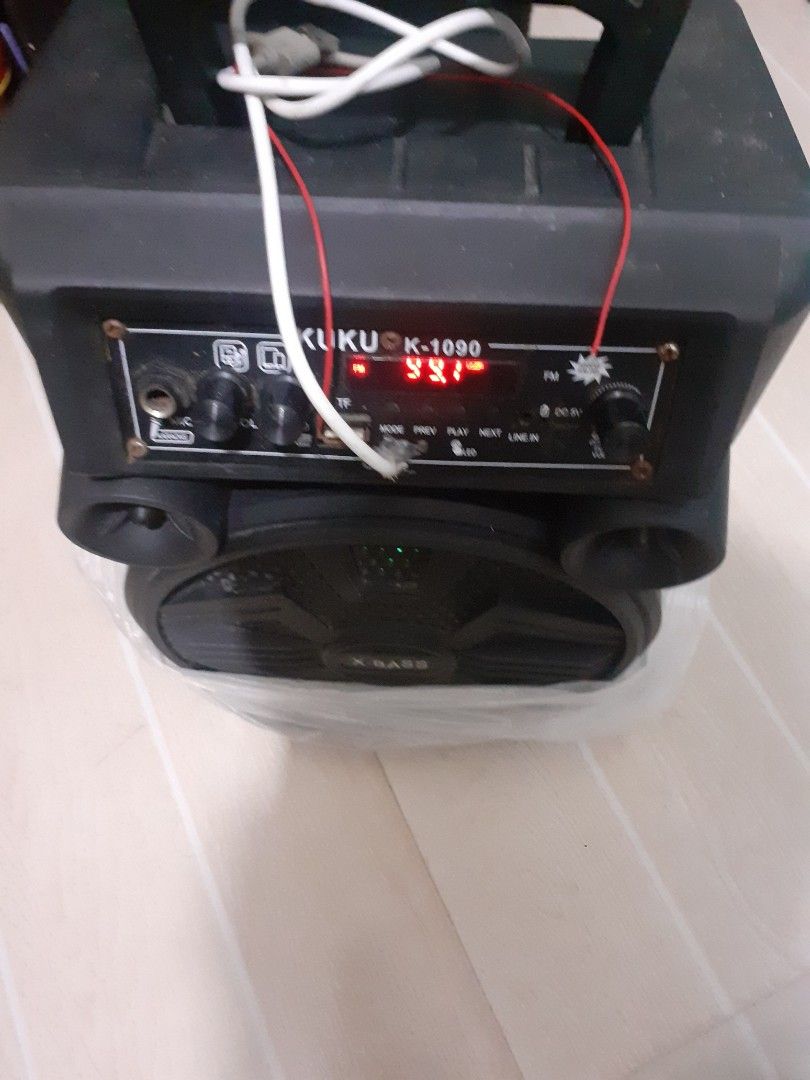 Kuku K-1090 Wireless Speaker with Microphone (Category: Soundbars, Speakers & Amplifiers) located in Lipa City. Submitted by newriver_a7c3ea (Listing ID 1428686615, Image 1). Description: Listing includes a Kuku K-1090 wireless speaker with a microphone. The speaker has multiple input options and a digital display. It also features LED lights. The speaker is black and has a built-in handle for easy carrying. The images also show other speakers, i