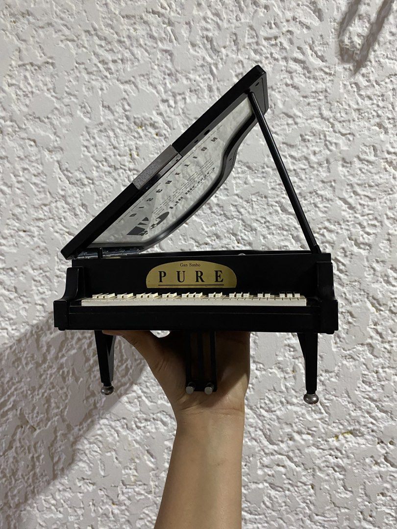 Mezzo Piano Musical accessory organizer (Category: Musical Instruments) located in Mabalacat. Submitted by ichibansurplus (Listing ID 1428731141, Image 2). Description: This item is a vintage Mezzo Piano musical accessory organizer shaped like a grand piano. It features whimsical text printed on the lid, including lyrics from Billy Joel’s “Piano Man” and the word “Discretion”. It functions as a music box and a small storage container for jewelry 