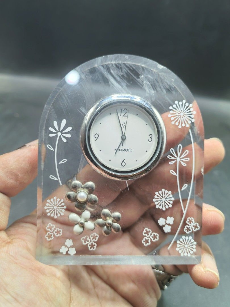 Mikimoto Table Clock (Category: Clocks) located in Cebu City. Submitted by dudes_villanueva (Listing ID 1428641133, Image 1). Description: Mikimoto Table Clock 📌Featuring a clear lucite arch design decorated with pearls and floral motifs. 📌Design: Arch-shaped clear lucite housing with embedded pearl accents and white floral patterns. 📌Type: Analog quartz desk or table clock. 📌Features: Often features high-quality Japanese craftsmanship typica