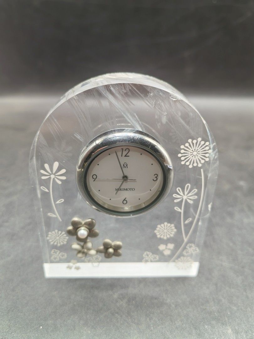 Mikimoto Table Clock (Category: Clocks) located in Cebu City. Submitted by dudes_villanueva (Listing ID 1428641133, Image 2). Description: Mikimoto Table Clock 📌Featuring a clear lucite arch design decorated with pearls and floral motifs. 📌Design: Arch-shaped clear lucite housing with embedded pearl accents and white floral patterns. 📌Type: Analog quartz desk or table clock. 📌Features: Often features high-quality Japanese craftsmanship typica