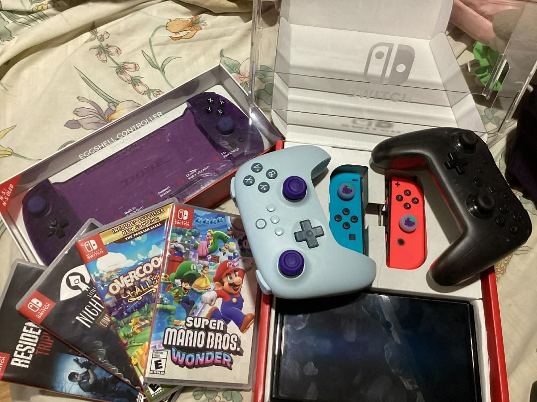 NINTENDO SWITCH OLED SLIGHTLY USED (Category: Nintendo) located in Caloocan City. Submitted by freefish.3b9e0a (Listing ID 1428613696, Image 1). Description: LIGHTLY USED, 3 years Old COMPLETE SET W/BOX AND ALL THE ACCESSORIES. Nintendo Switch Console With Red/Blue Joycon (OLED Model) Standalone ACCESSORIES: Nintendo Switch Bag (pink & gray) Dobe Eggshell Controller for Switch/Switch OLED (Transparent Purple) NSW OIVO Carry Case FOR N-Switch / N-