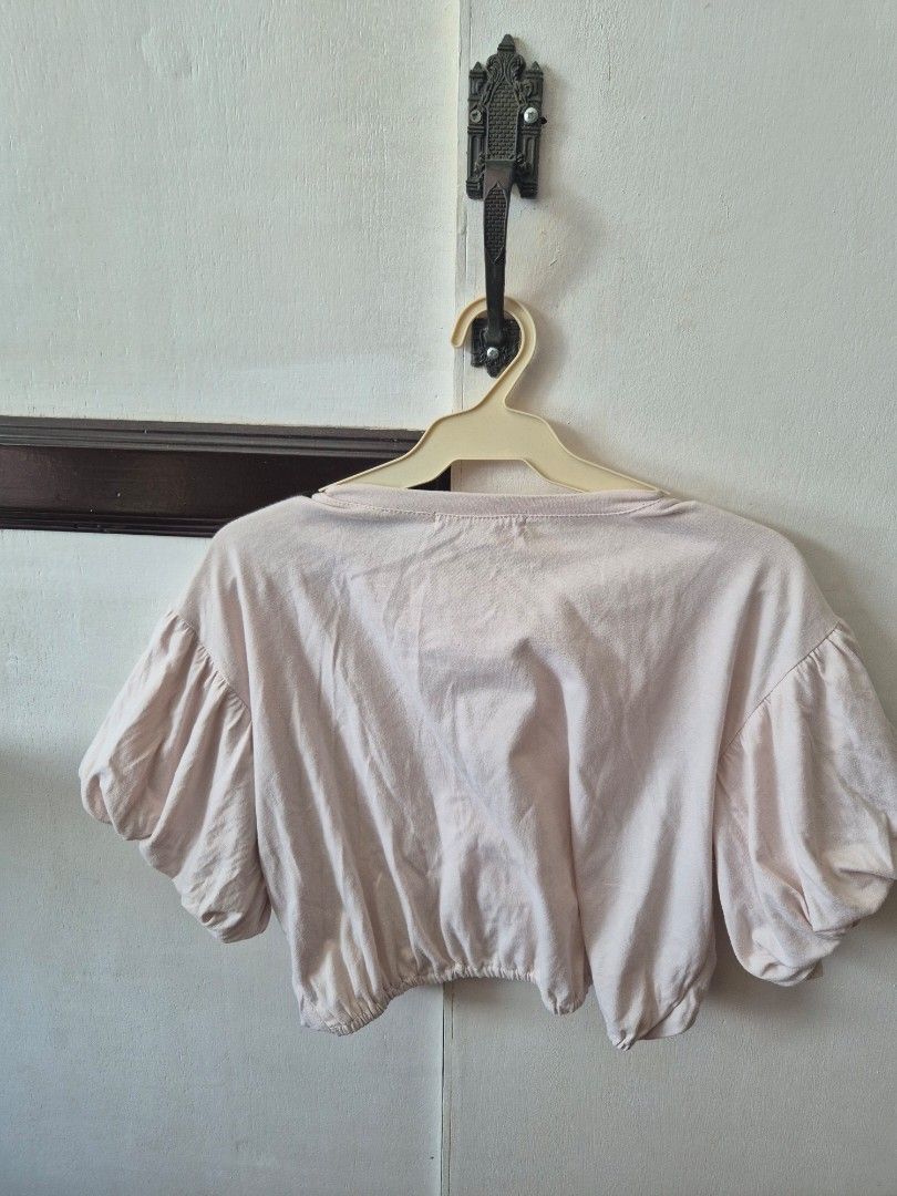 Puff sleeves Crop Top (Category: Blouses) located in Manila. Submitted by the_cabinetdeclutter (Listing ID 1428624530, Image 2). Description: Size: Medium on tag but preferably Small since crop top Color: Beige Condition: Medyo loose na yung garter sa likod. Super pretty nito suotin but I don't have when worn photo.