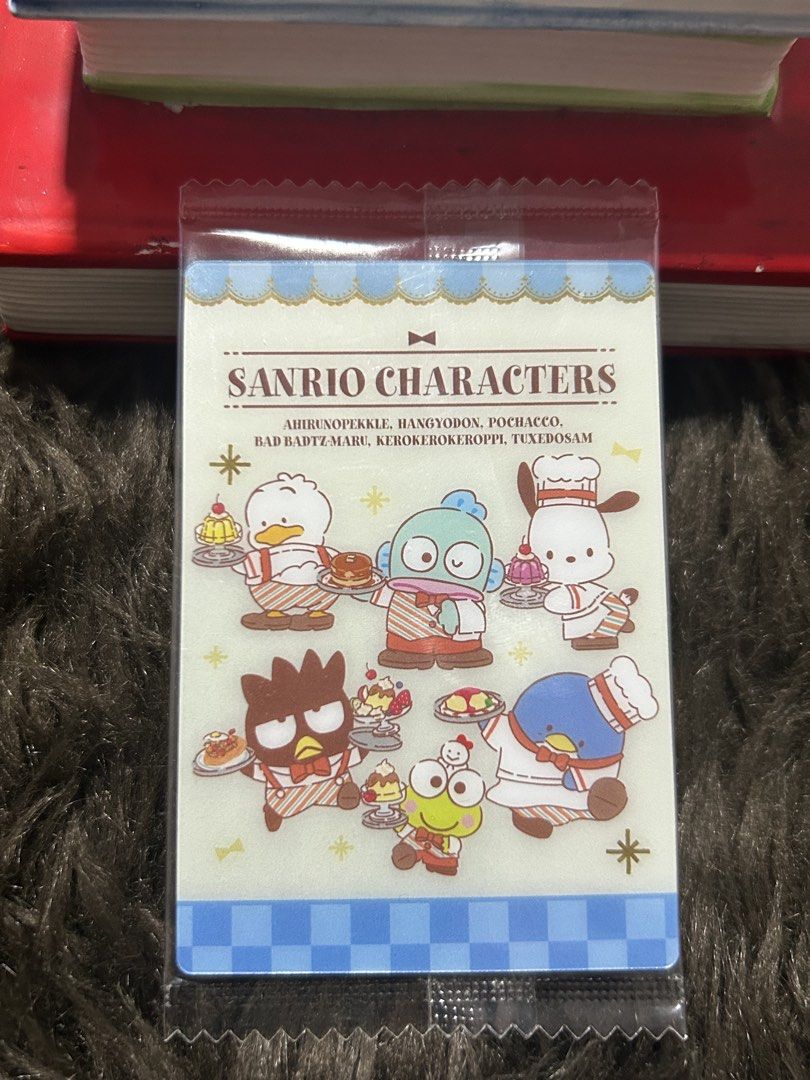 Sanrio Characters Trading Card (Category: Raw Singles) located in Angeles City. Submitted by zyeplustradings (Listing ID 1428632331, Image 1). Description: Sanrio Characters trading card featuring various characters. The card is in its original packaging. The front of the card displays several Sanrio characters with food. The back of the card has Japanese text and more character illustrations. It is a 2023 Sanrio product..