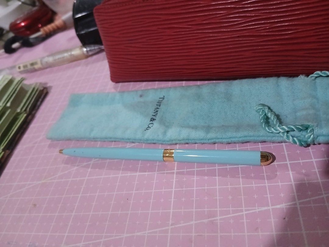 Tiffany & Co. Pen (Category: Luxury Accessories) located in San Pedro. Submitted by whatandeverdelights (Listing ID 1416452750, Image 3). Description: - Tiffany & Co. pen - Light blue color - Gold-colored accents - Includes matching pouch - Perfect for gifts or everyday use - All sales final.