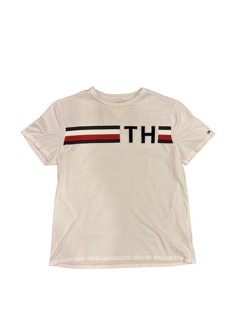 Tommy Hilfiger T-Shirt (Category: Tshirts & Polo Shirts ) located in Makati City. Submitted by justeprix (Listing ID 1428764966, Image 1). Description: Like new unisex Tommy Hilfiger T-shirt Authentic purchase from the US rfs: decluttering Size: Medium Chest: 51 cm Length: 64 cm Shoulder: 44 cm Sleeve: 20 cm Shipping from MAKATI CITY via Lalamove, Grab, Angkas Padala, etc. Booking will be set up by Juste Prix and cost will be shouldered by buyer.