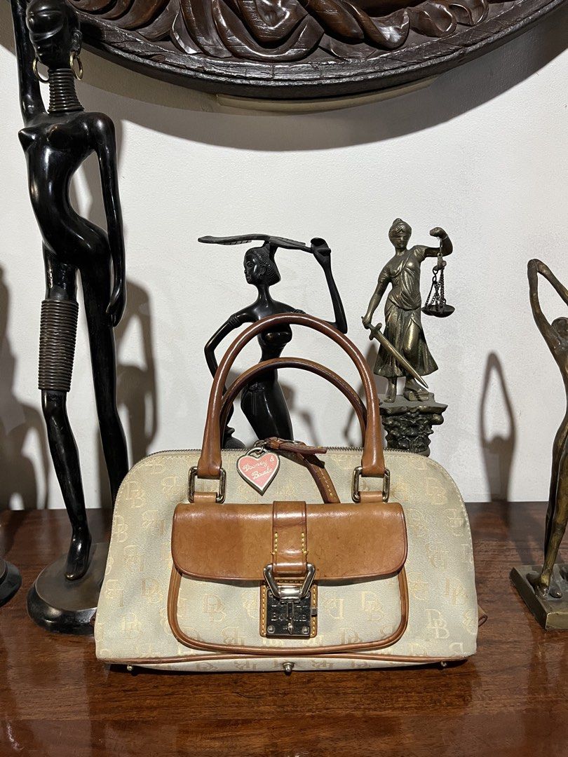 Vintage Dooney & Bourke Monogram Handbag (Category: Luxury Bags & Wallets) located in Quezon City. Submitted by bambibear19 (Listing ID 1428667387, Image 1). Description: well used canvas is aged and slightly worn at the edges stains on interior along zipper lock is functional ⋆‧°𓏲ּ𝄢 quezon city dm for details :).