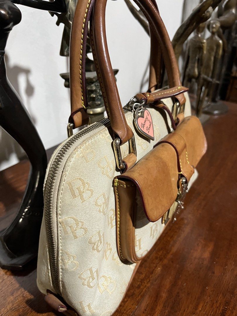Vintage Dooney & Bourke Monogram Handbag (Category: Luxury Bags & Wallets) located in Quezon City. Submitted by bambibear19 (Listing ID 1428667387, Image 2). Description: well used canvas is aged and slightly worn at the edges stains on interior along zipper lock is functional ⋆‧°𓏲ּ𝄢 quezon city dm for details :).