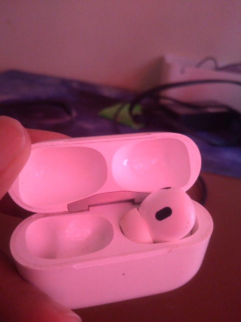 Apple AirPods Pro (Category: Earphones) located in Dasmarinas. Submitted by mspaupreloveditems (Listing ID 1428846023, Image 2). Description: Apple AirPods Pro 1st gen A2803 with charging case. The case has a button and a charging port. The earbuds are white and have a black mesh on the earbud. The case is marked "Designed by Apple in California Assembled in USA". issue: no left airpods no charger pwede sa andriod malakas ang sounds kahit right l