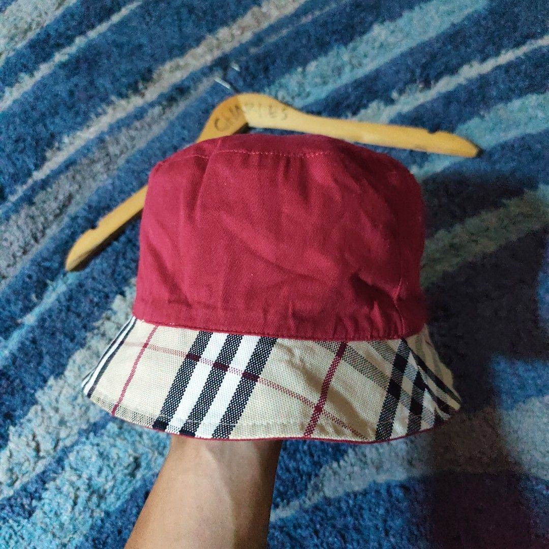 Burberry Reversible Bucket Hat (Category: Luxury Accessories) located in Caloocan City. Submitted by fast_transact (Listing ID 1428893065, Image 3). Description: Authentic Burberry reversible bucket hat. Features the classic Burberry check pattern on one side and a solid red color on the other. The hat has a small Burberry label. Perfect for adding a touch of luxury to any outfit..