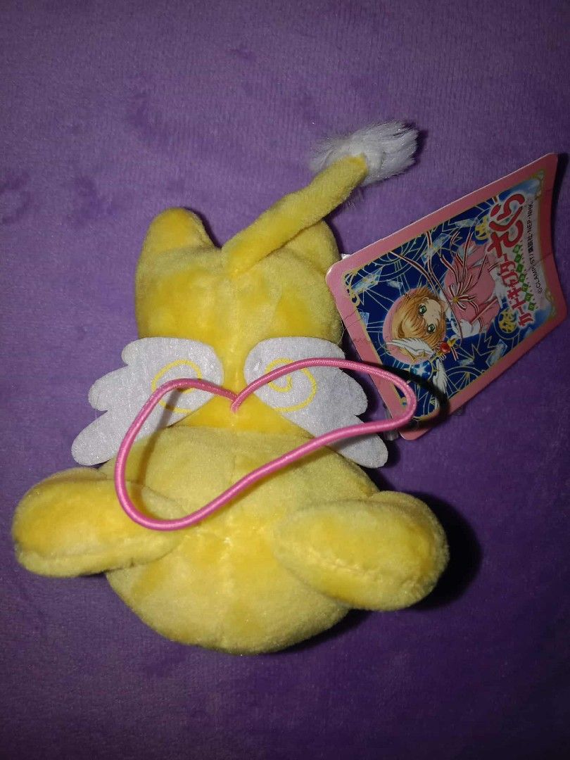 Cardcaptor Sakura Kero-chan Plush Keychain (Category: Plushies & Soft Toys) located in Dagupan City. Submitted by gentlemountain-afad44 (Listing ID 1428807258, Image 3). Description: Adorable Kero-chan plush keychain from Cardcaptor Sakura. Features a yellow body with small black eyes and a cute little mouth. Includes a pink string for easy attachment. Comes with the original tag. Perfect for fans of the series or collectors..
