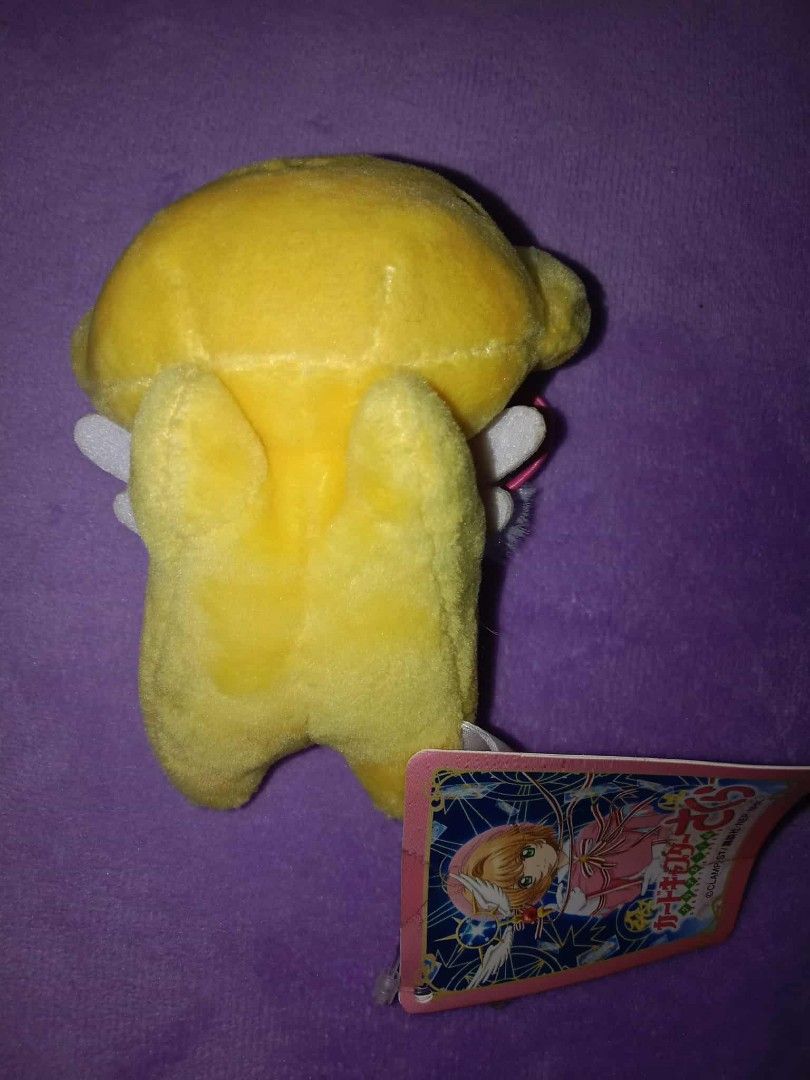 Cardcaptor Sakura Kero-chan Plush Keychain (Category: Plushies & Soft Toys) located in Dagupan City. Submitted by gentlemountain-afad44 (Listing ID 1428807258, Image 2). Description: Adorable Kero-chan plush keychain from Cardcaptor Sakura. Features a yellow body with small black eyes and a cute little mouth. Includes a pink string for easy attachment. Comes with the original tag. Perfect for fans of the series or collectors..
