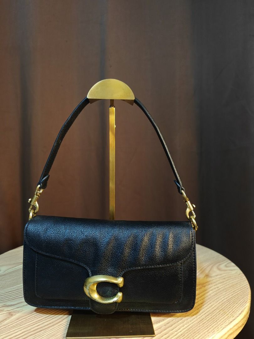 Coach Tabby Shoulder Bag 26 (Category: Luxury Bags & Wallets) located in Pasig City. Submitted by mightyflower.0f5aa6 (Listing ID 1428821517, Image 1). Description: Black Coach Tabby Shoulder Bag 26. Features a flap closure with the signature Coach "C" logo in gold-tone hardware. Includes a top handle and a detachable shoulder strap..