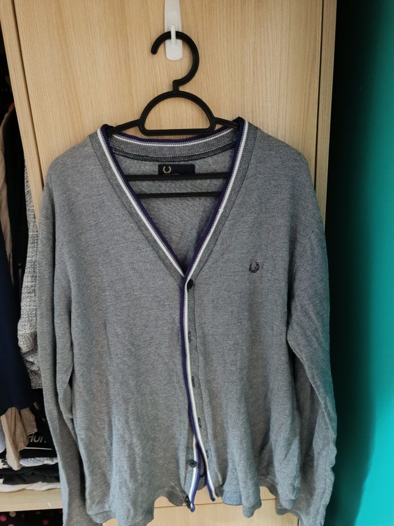Fred Perry Cardigan - XL (Category: Coats, Jackets and Outerwear) located in Trece Martires City. Submitted by declutterbyedi (Listing ID 1428829128, Image 1). Description: Gray Fred Perry cardigan with a V-neck design. Features a small embroidered logo on the chest and a contrasting trim along the collar and button line. The size is XL. The cardigan has a button-up front closure..