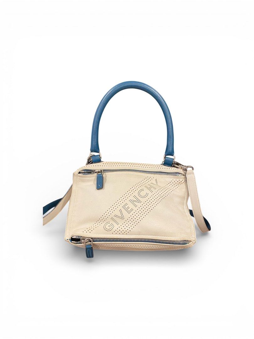 Givenchy Pandora Small Handbag (Category: Luxury Bags & Wallets) located in Mandaluyong City. Submitted by loved_curated (Listing ID 1428812167, Image 1). Description: Givenchy Pandora Small handbag in off-white leather with blue handles and accents. Features a perforated Givenchy logo on the front. Includes a top handle and a detachable shoulder strap. The bag has multiple zippered compartments. It has a dust bag & tags. .