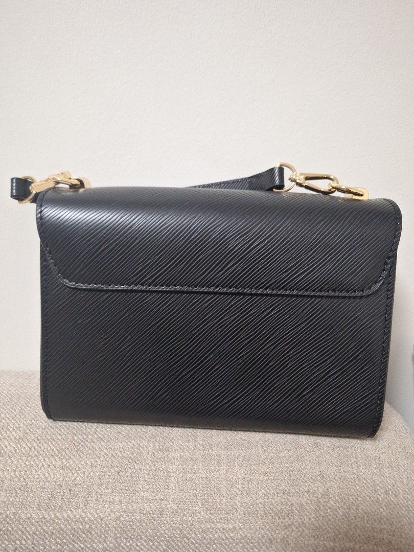 Louis Vuitton Twist PM Black (Category: Luxury Bags & Wallets) located in Manila. Submitted by loydamariano (Listing ID 1428807338, Image 2). Description: Elegant Louis Vuitton Twist PM handbag in black. Features a gold-tone LV twist lock closure. Includes a detachable shoulder strap with Louis Vuitton branding. The interior has multiple compartments for organization. It has a chain strap and gold-tone hardware..