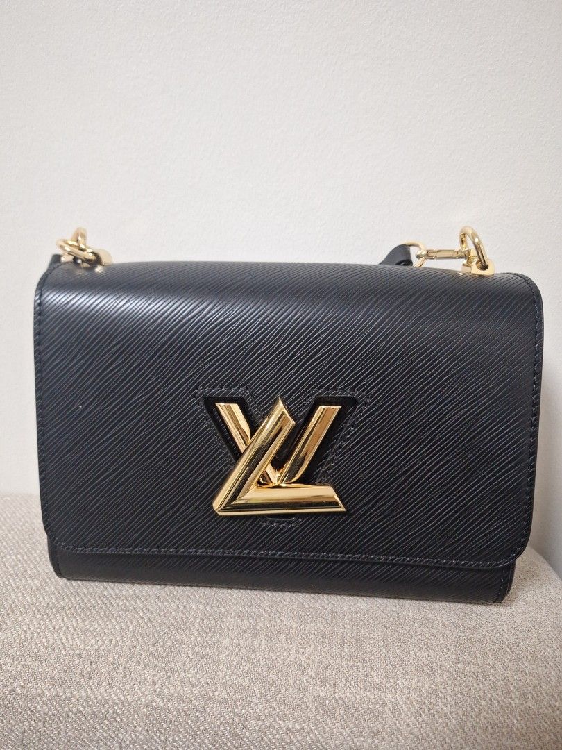 Louis Vuitton Twist PM Black (Category: Luxury Bags & Wallets) located in Manila. Submitted by loydamariano (Listing ID 1428807338, Image 1). Description: Elegant Louis Vuitton Twist PM handbag in black. Features a gold-tone LV twist lock closure. Includes a detachable shoulder strap with Louis Vuitton branding. The interior has multiple compartments for organization. It has a chain strap and gold-tone hardware..