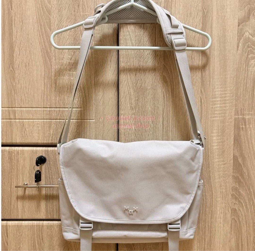 MAH Light Gray Messenger Bag (Unisex) (Category: Sling Bags) located in Quezon City. Submitted by amoree.shop (Listing ID 1428884544, Image 3). Description: HELLO! PLEASE READ ✨ Actual Photo Posted. - Light gray messenger bag - Adjustable shoulder strap - Multiple compartments for organization - Includes side pockets and zippered main compartment - Perfect for carrying wallet, tablet, phone, tissue, cup, and umbrella - Dimensions: Approximately 3