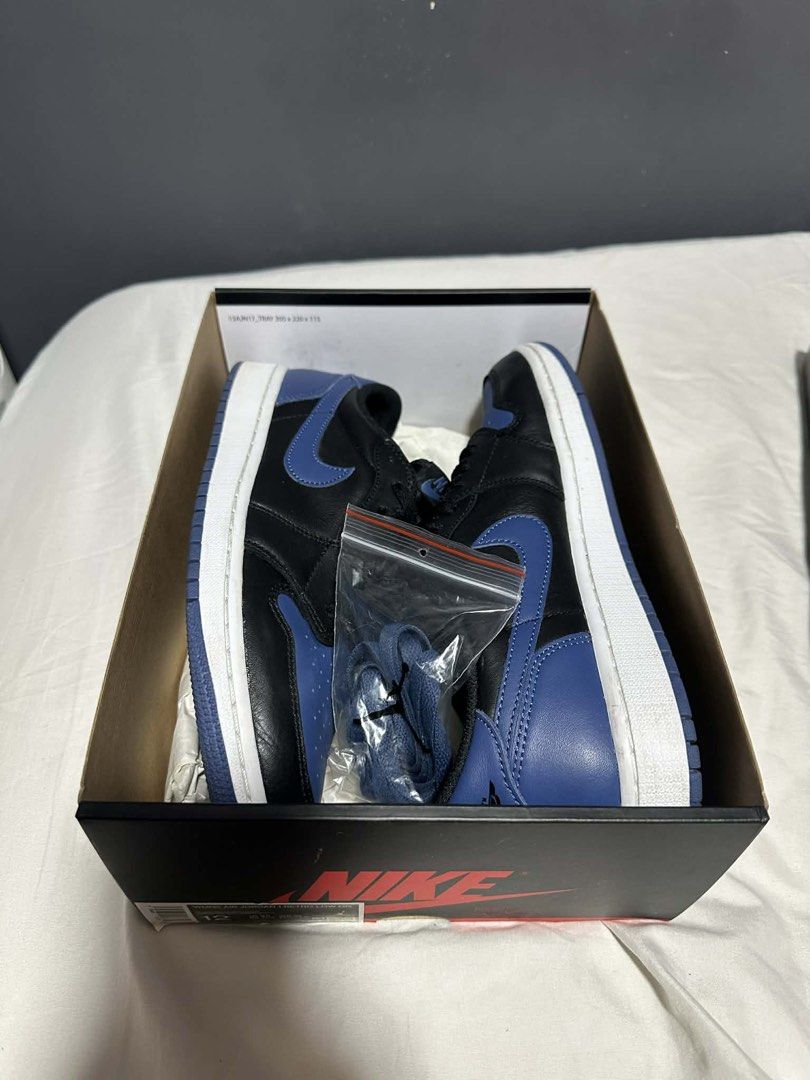 Nike Air Jordan 1 Retro Low OG (Category: Sneakers) located in Mandaluyong City. Submitted by getbounced (Listing ID 1428985406, Image 3). Description: Air Jordan 1 Retro Low OG in black and blue colorway. Comes with the original box and extra laces. The shoes have a white midsole and blue outsole. The size is US 12..