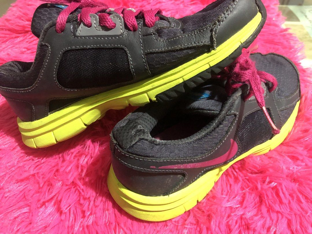 Nike Running Shoes - Size 2Y (Category: Babies & Kids Fashion) located in Mandaluyong City. Submitted by jennyitems (Listing ID 1428975475, Image 3). Description: 👟Nike running shoes in a grey and neon yellow colorway. 👟Features pink laces and a pink Nike swoosh. 👟The shoes have a blue Nike logo on the tongue. 👟The soles show some wear. 👟Sizes 2Y..