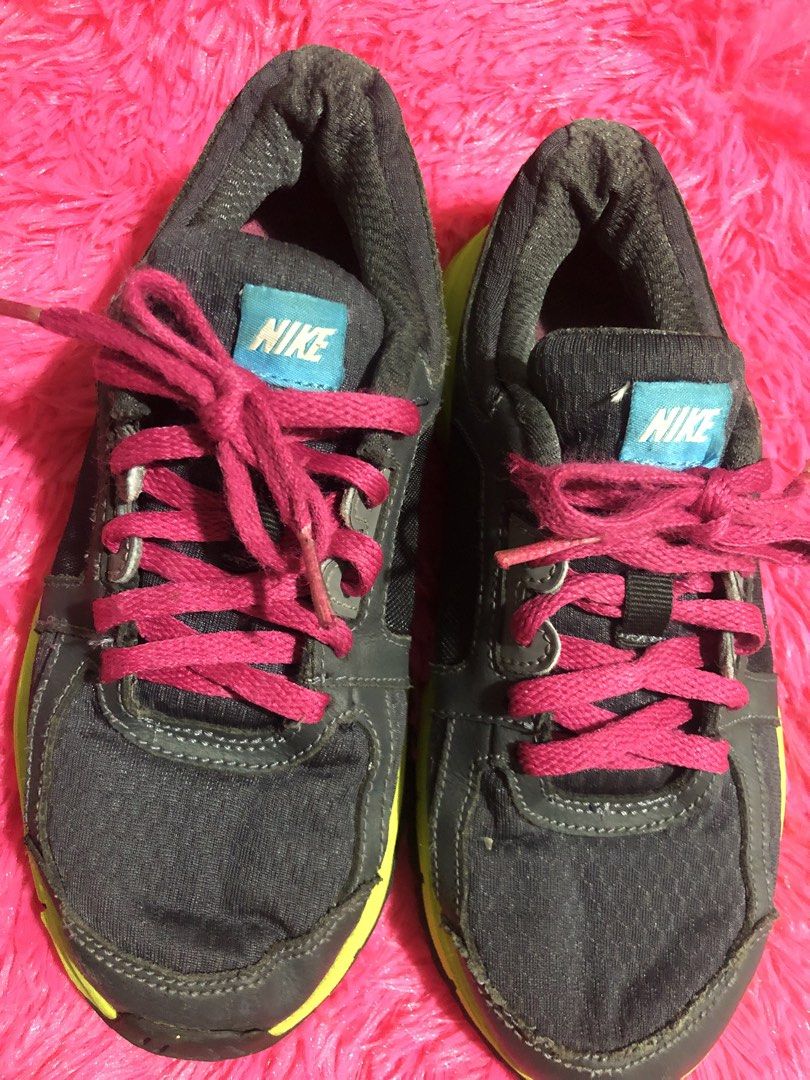 Nike Running Shoes - Size 2Y (Category: Babies & Kids Fashion) located in Mandaluyong City. Submitted by jennyitems (Listing ID 1428975475, Image 2). Description: 👟Nike running shoes in a grey and neon yellow colorway. 👟Features pink laces and a pink Nike swoosh. 👟The shoes have a blue Nike logo on the tongue. 👟The soles show some wear. 👟Sizes 2Y..