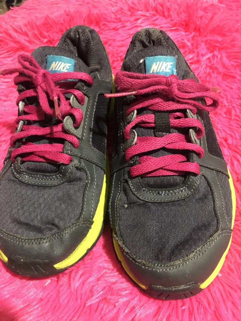 Nike Running Shoes - Size 2Y (Category: Babies & Kids Fashion) located in Mandaluyong City. Submitted by jennyitems (Listing ID 1428975475, Image 1). Description: 👟Nike running shoes in a grey and neon yellow colorway. 👟Features pink laces and a pink Nike swoosh. 👟The shoes have a blue Nike logo on the tongue. 👟The soles show some wear. 👟Sizes 2Y..