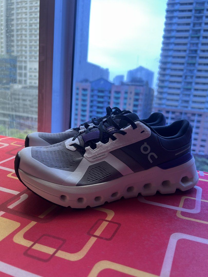 On CloudTec Running Shoes - US M8 (Category: Sneakers) located in Makati City. Submitted by nicolaylay (Listing ID 1428987846, Image 3). Description: On CloudTec running shoes in a white, grey, and purple colorway. Features a breathable mesh upper and a cushioned sole. The shoes have a lace-up closure and the On logo is visible on the side. The size is US M8, EU 41, and JP 26. Made in Vietnam..