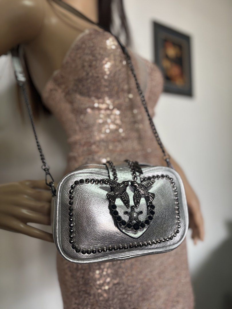 Pinko Silver Crossbody Bag with Studs (Category: Luxury Bags & Wallets) located in Davao. Submitted by emmanuelchuamellorin23 (Listing ID 1428818233, Image 3). Description: Silver crossbody bag from Pinko. Features a chain strap and a decorative bird emblem on the front. The bag is adorned with studs around the edges. The bag has a flap closure..
