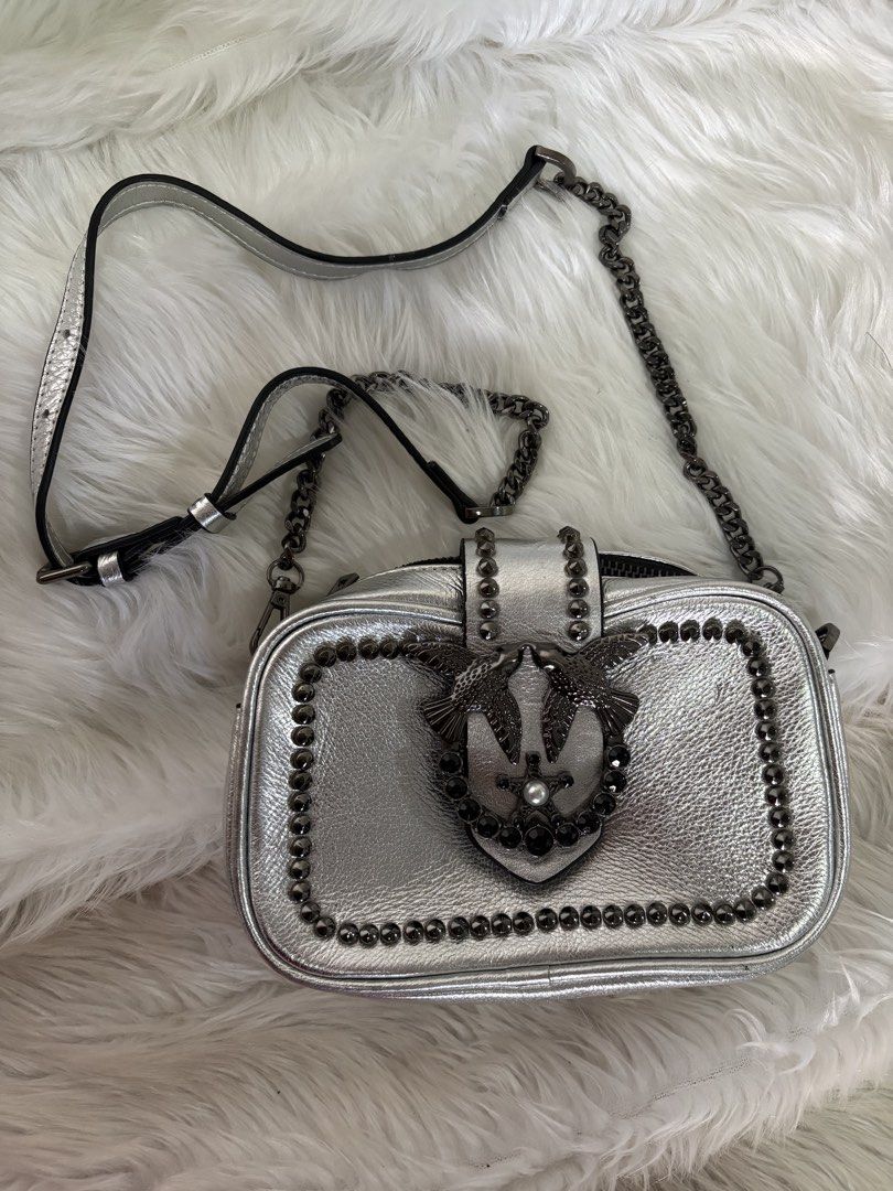 Pinko Silver Crossbody Bag with Studs (Category: Luxury Bags & Wallets) located in Davao. Submitted by emmanuelchuamellorin23 (Listing ID 1428818233, Image 1). Description: Silver crossbody bag from Pinko. Features a chain strap and a decorative bird emblem on the front. The bag is adorned with studs around the edges. The bag has a flap closure..