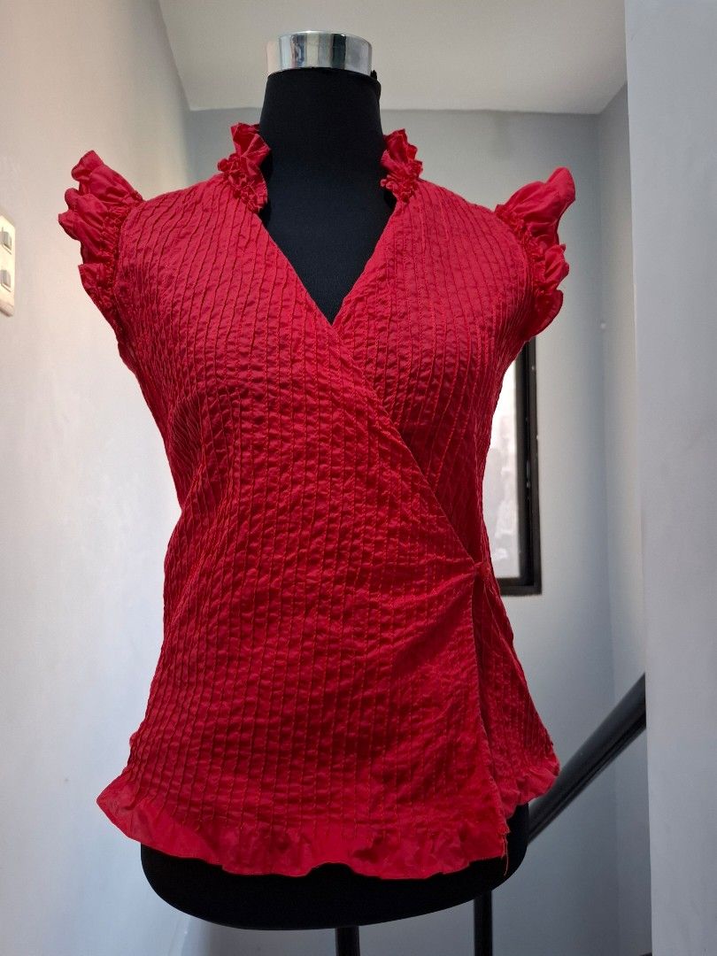 R.A.F. Plains & Prints Red Blouse (Category: Blouses) located in Manila. Submitted by jazil.ladyliz (Listing ID 1428799504, Image 1). Description: Red blouse from R.A.F. Plains & Prints. Features a V-neck design with ruffled sleeves. The blouse has a textured fabric. Size 15/300. Made in the Philippines..