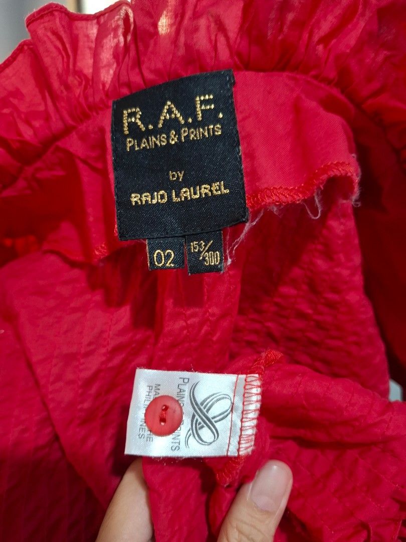 R.A.F. Plains & Prints Red Blouse (Category: Blouses) located in Manila. Submitted by jazil.ladyliz (Listing ID 1428799504, Image 2). Description: Red blouse from R.A.F. Plains & Prints. Features a V-neck design with ruffled sleeves. The blouse has a textured fabric. Size 15/300. Made in the Philippines..