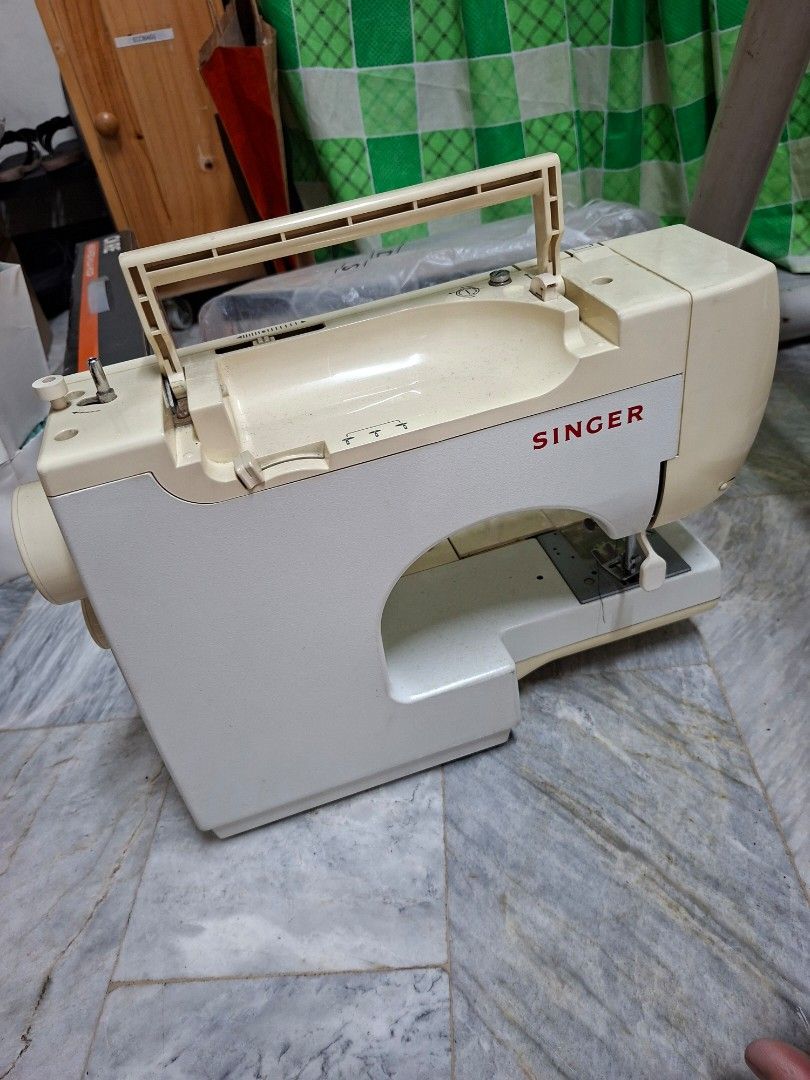 Singer Sewing Machine (Category: Craft Supplies & Tools) located in Manila. Submitted by mochibibi (Listing ID 1428881932, Image 2). Description: Singer sewing machine. Features various stitch patterns and settings. Includes a power cord and other accessories issue: top part is missing a stand where you put the roll of thread. no effect on the machine itself..