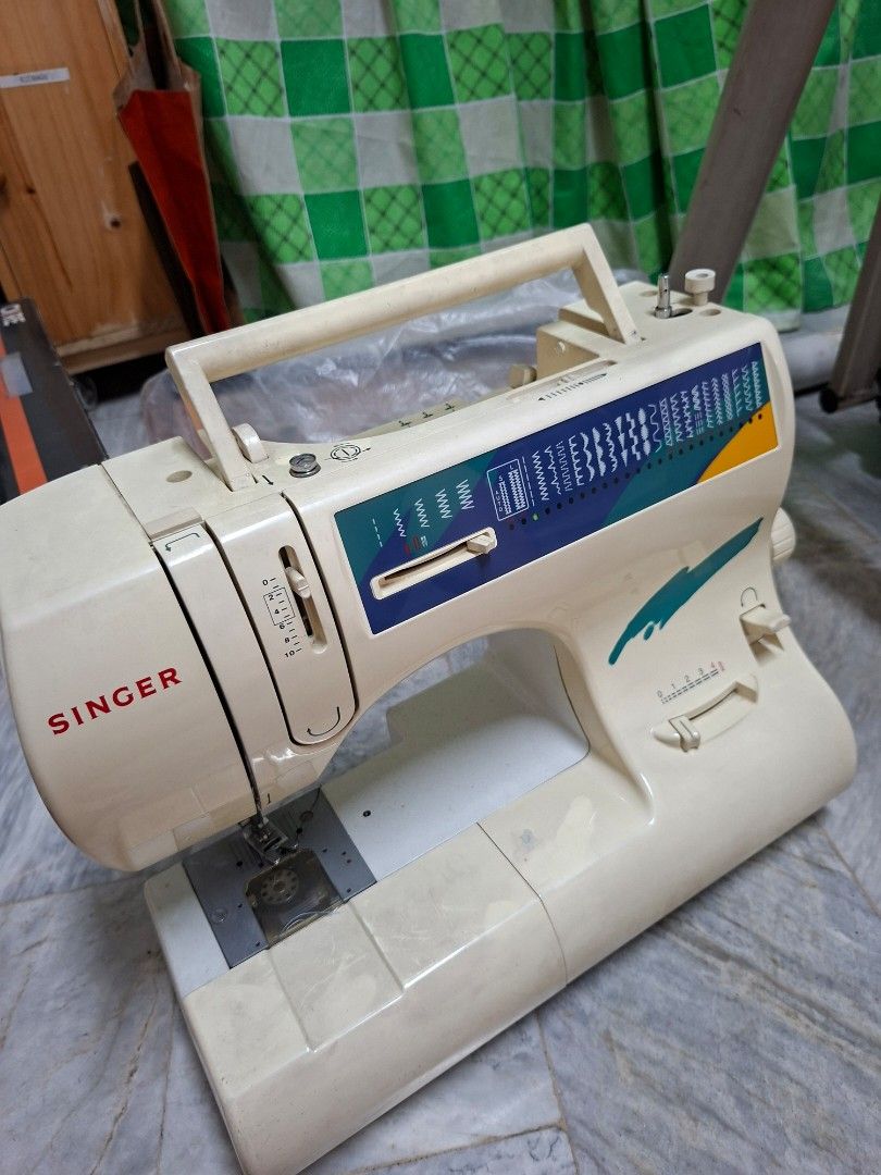 Singer Sewing Machine (Category: Craft Supplies & Tools) located in Manila. Submitted by mochibibi (Listing ID 1428881932, Image 1). Description: Singer sewing machine. Features various stitch patterns and settings. Includes a power cord and other accessories issue: top part is missing a stand where you put the roll of thread. no effect on the machine itself..