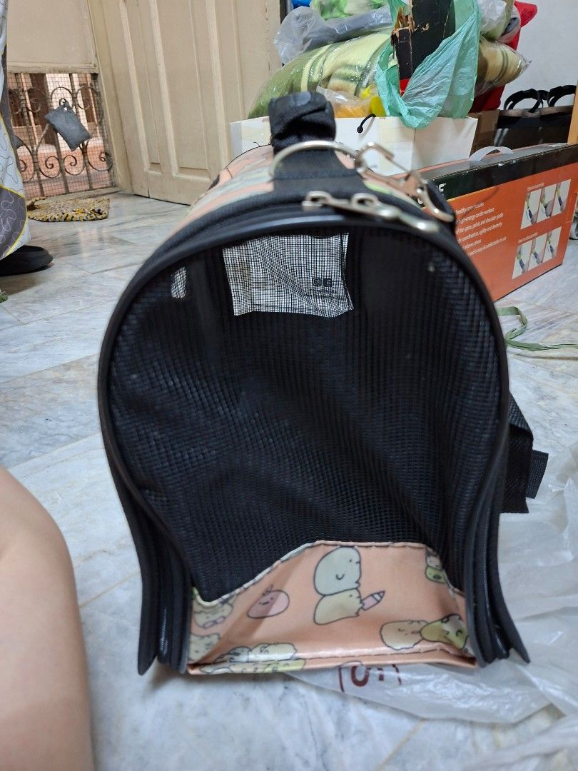 Sumikko Gurashi Pet Carrier Bag (Category: Homes & Other Pet Accessories) located in Manila. Submitted by mochibibi (Listing ID 1428882845, Image 3). Description: Pet carrier bag features a cute Sumikko Gurashi design. It has a mesh window for ventilation and a zipper closure. The bag includes a handle and a shoulder strap for easy carrying. The interior is black, and the exterior has a pink background with Sumikko Gurashi characters..